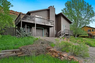 a house with a balcony and a yard at Horsetooth Stoop Trails, Lake Access and Mountain Views in Fort Collins
