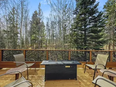 a patio with chairs and a table on a deck at Cutty Sark Court #1 3BR Mountain Views townhouse in Silverthorne