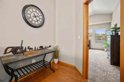 a room with a clock on the wall and a table at Cutty Sark Court #1 3BR Mountain Views townhouse in Silverthorne