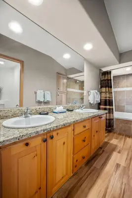 a bathroom with two sinks and a large mirror at Cutty Sark Court #1 3BR Mountain Views townhouse in Silverthorne