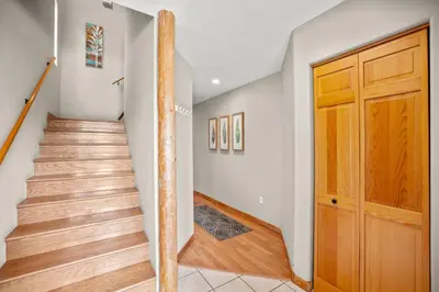 a staircase in a house with a wooden door at Cutty Sark Court #1 3BR Mountain Views townhouse in Silverthorne