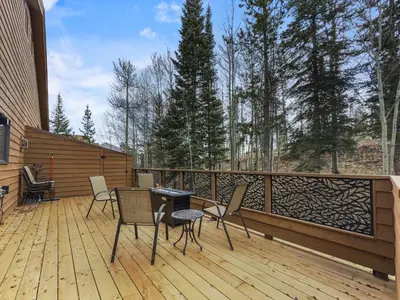 a patio with chairs and a table on a deck at Cutty Sark Court #2 3BR Mountain Views townhouse in Silverthorne