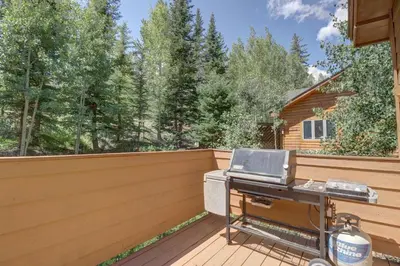 a grill on a deck with a fence at Cutty Sark Court #2 3BR Mountain Views townhouse in Silverthorne
