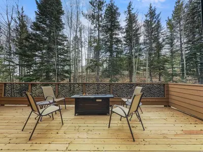 a patio with three chairs and a table on a deck at Cutty Sark Court #2 3BR Mountain Views townhouse in Silverthorne