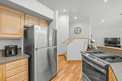 a kitchen with a stainless steel refrigerator and a stove at Cutty Sark Court #2 3BR Mountain Views townhouse in Silverthorne