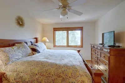 a bedroom with a bed and a television and a dresser at 75 Corinthian 3Br 3Ba Spacious Layout, Private Garage townhouse in Dillon