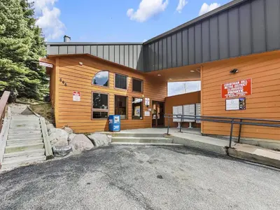 a wooden building with a parking lot in front of it at 75 Corinthian 3Br 3Ba Spacious Layout, Private Garage townhouse in Dillon