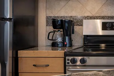 a kitchen with a stove and a coffee maker on a counter at Iron Horse C5083 condo in Winter Park