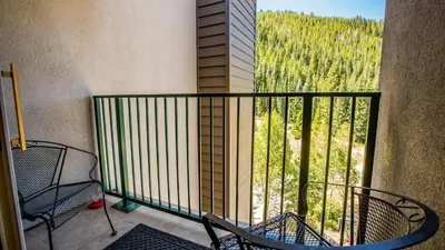 a balcony with chairs and a view of a mountain at Iron Horse C5083 condo in Winter Park