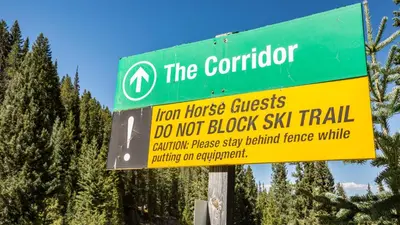 a green and yellow sign for a hot house crisis do not block ski trail at Iron Horse C5083 condo in Winter Park
