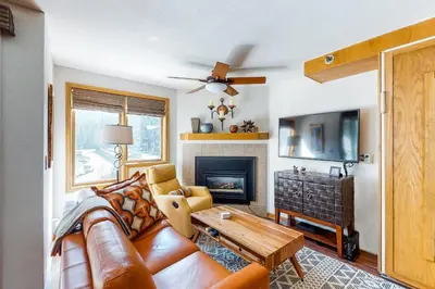 a living room with a couch and a fireplace at Iron Horse Studio Retreat in Winter Park