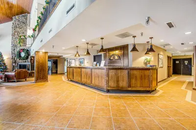 an open lobby with a reception desk and a christmas tree at Iron Horse Studio Retreat in Winter Park