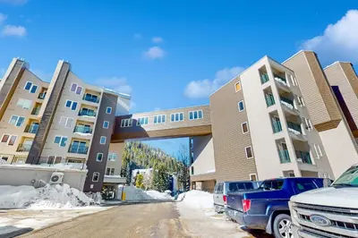 a parking lot with cars parked in front of buildings at Iron Horse Studio Retreat in Winter Park