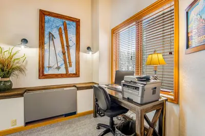 an office with a computer on a desk with a window at Iron Horse Studio Retreat in Winter Park