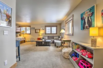 a living room with a couch and a table at Frisco Home with Mountain Views Walk to Main St! in Frisco