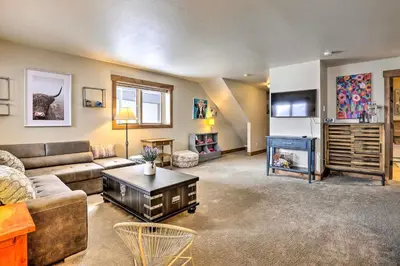 a living room with a couch and a table at Frisco Home with Mountain Views Walk to Main St! in Frisco