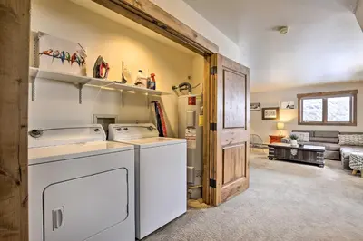 a kitchen with a washer and dryer in a room at Frisco Home with Mountain Views Walk to Main St! in Frisco