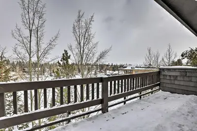 a fence covered in snow with trees in the background at Frisco Home with Mountain Views Walk to Main St! in Frisco
