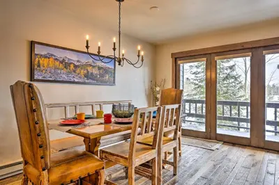 a dining room with a wooden table and chairs at Frisco Home with Mountain Views Walk to Main St! in Frisco
