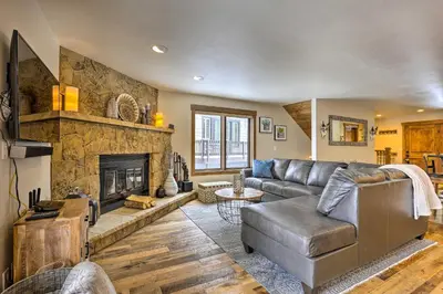 a living room with a couch and a fireplace at Frisco Home with Mountain Views Walk to Main St! in Frisco