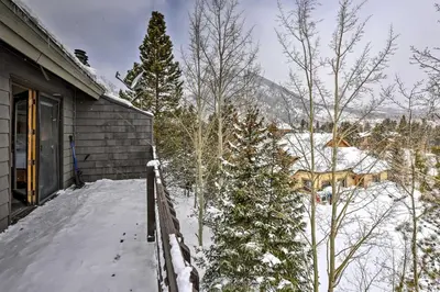 a house covered in snow next to some trees at Frisco Home with Mountain Views Walk to Main St! in Frisco