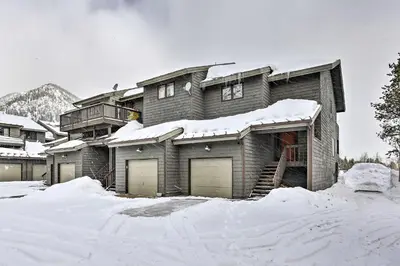 a snow covered house with two garage at Frisco Home with Mountain Views Walk to Main St! in Frisco