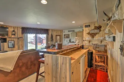 a kitchen with wooden cabinetry and a counter top at Deck, Bar and Mtn Views Grand Granby Retreat! in Granby