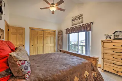 a bedroom with a bed and a ceiling fan at Deck, Bar and Mtn Views Grand Granby Retreat! in Granby