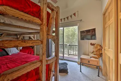 a bedroom with two bunk beds and a teddy bear sitting on a dresser at Deck, Bar and Mtn Views Grand Granby Retreat! in Granby
