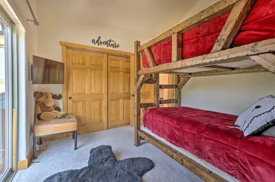 a bedroom with two bunk beds and a teddy bear at Deck, Bar and Mtn Views Grand Granby Retreat! in Granby