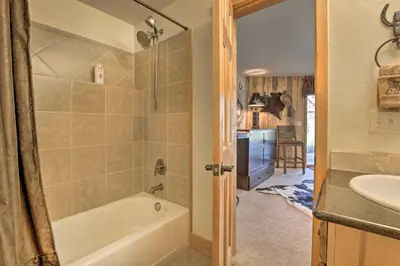 a bathroom with a tub and a sink at Deck, Bar and Mtn Views Grand Granby Retreat! in Granby