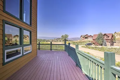 a wooden walkway on the side of a house at Deck, Bar and Mtn Views Grand Granby Retreat! in Granby