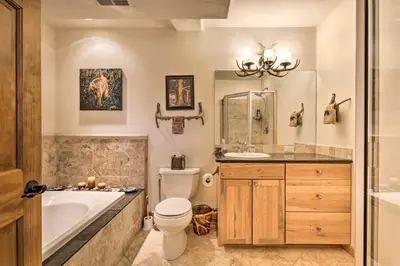 a bathroom with a tub and a toilet and a sink at Deck, Bar and Mtn Views Grand Granby Retreat! in Granby