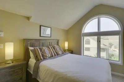 a bedroom with a bed and a large window at Walk to Ski Lifts Mtn-View Granby Retreat! in Granby