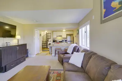 a living room with a couch and a kitchen at Walk to Ski Lifts Mtn-View Granby Retreat! in Granby