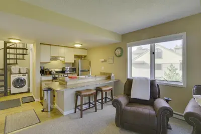 a kitchen and living room with a couch and a table at Walk to Ski Lifts Mtn-View Granby Retreat! in Granby