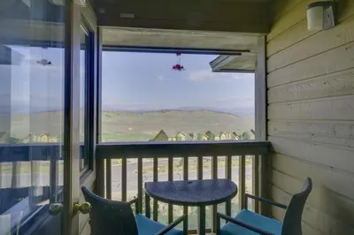 a balcony with chairs and a table and a window at Walk to Ski Lifts Mtn-View Granby Retreat! in Granby