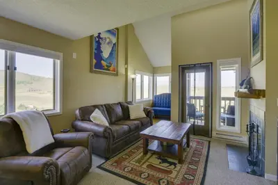 a living room with leather couches and a table at Walk to Ski Lifts Mtn-View Granby Retreat! in Granby