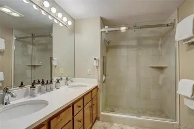 a bathroom with a shower and a sink and a tub at Jackpine Lodge 2 Bedroom Condo in Keystone