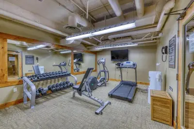 a gym with treadmills and machines in a room at Jackpine Lodge 2 Bedroom Condo in Keystone