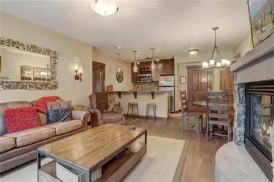 a living room with a couch and a fireplace at 2 Bedroom Blackbear Lodge Condo In River Run Village in Keystone