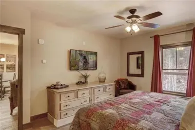 a bedroom with a bed and a ceiling fan at 2 Bedroom Blackbear Lodge Condo In River Run Village in Keystone