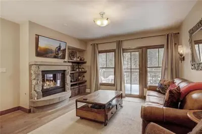 a living room with a couch and a fireplace at 2 Bedroom Blackbear Lodge Condo In River Run Village in Keystone