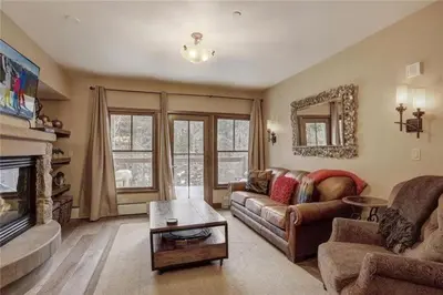 a living room with a couch and a fireplace at 2 Bedroom Blackbear Lodge Condo In River Run Village in Keystone