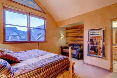 a bedroom with a large bed and a window at Black Bear Lodge 3 Bedroom Condo In River Run Village in Keystone