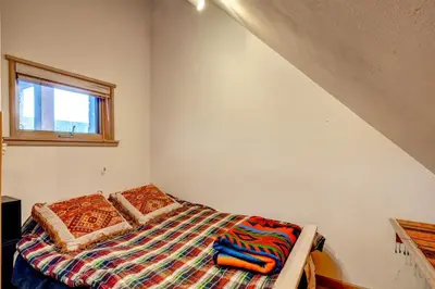 a bedroom with a bed and a window at Black Bear Lodge 3 Bedroom Condo In River Run Village in Keystone