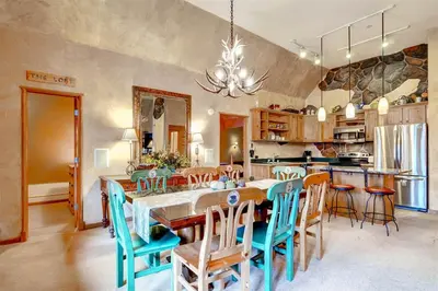 a kitchen and dining room with a table and chairs at Black Bear Lodge 3 Bedroom Condo In River Run Village in Keystone