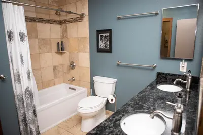 a bathroom with a toilet and a tub and a sink at 1221 Keystone Gulch condo in Keystone