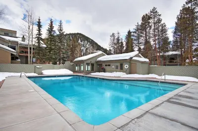 a swimming pool in a yard with a house at 1221 Keystone Gulch condo in Keystone