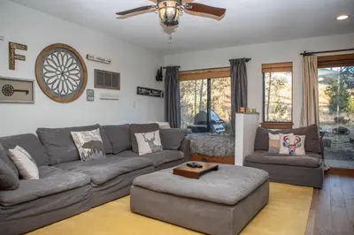a living room with a gray couch and a fan at 1221 Keystone Gulch condo in Keystone
